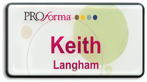 A black border regal name badge with white background with the leyend: "Keith Langham"